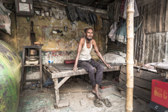 Man on a Britsche of a workshop, Dhaka, Bangladesh, Asia