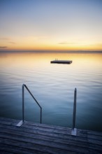 Sunset at Weiden on the lake with ladder and swimming island