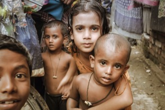 Khulna, Bangladesh, circa July 2012: Young native children with brown hair and brown eyes look