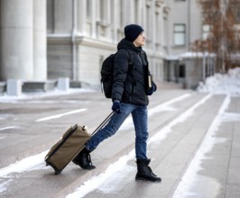 Portrait male student with books luggage