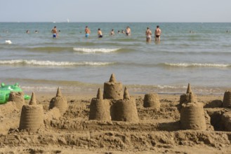 Several sandcastles on the beach off the coast - beach holiday