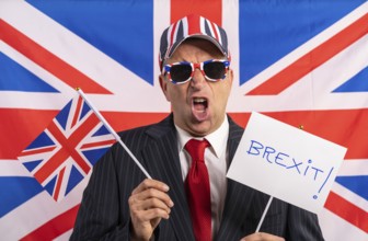 British male businessman with Brexit banner and UK flag