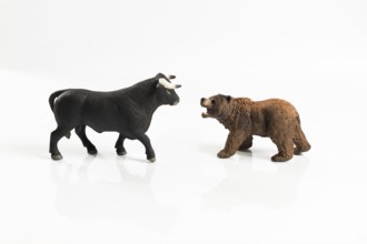 Stock market, securities trading and capitalism concept with a bull and bear concepts. On white