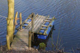 Handmade raft from shelves and plastic containers in the water