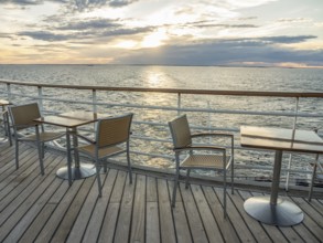 Terrace on the sea at sunset, empty tables and chairs, quiet atmosphere, svaneke, bornholm, baltic