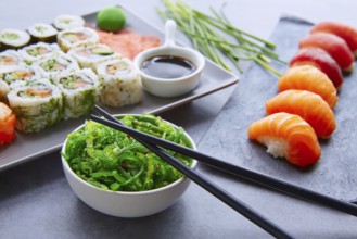 Enjoy sushi maki and nigiri served with wasabi and seaweed salad
