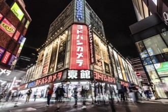 TOKYO, JAPAN - MAY 18 2019: Neon signs illuminate Tokyo's busy Shinjuku neighborhood at night