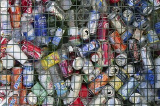 Assorted beverages cans on the trash, colored texture
