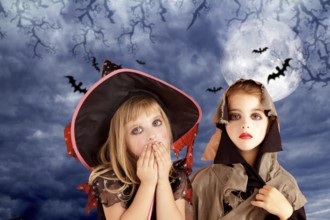 Halloween costumes kid girls on moon night sky with bats