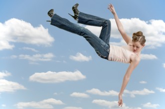 A beautiful young teenage woman falling through the sky