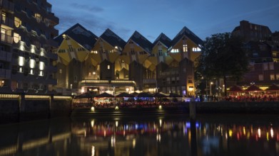 Night view of waterside with outdoor cafes near the cubes houses in Rotterdam, Netherlands