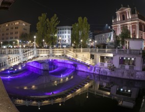 Famous three bridges at the Preseren square in the center of Ljubljana colorfully illuminated at