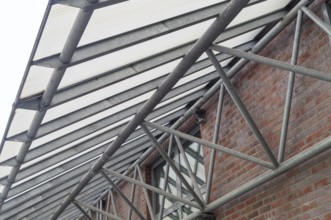 Large metal canopy with supports from below