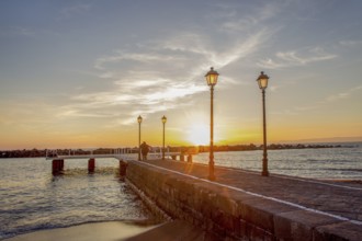Orange unset at Gulf of Naples>Pirs and Lamps and recognizable people at far distance