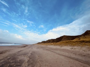 Beach walk on a deserted sandy beach under a blue sky