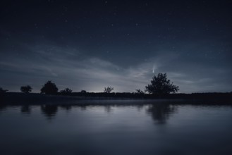 An image of a night scenery with comet Neowise
