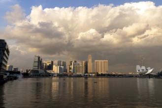 Skyline at sunset with thundercloud, Marina Bay, Singapore, Singapore, Asia