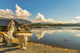 Stone figure, harbour, fishing village Norway, Valsøyfjorden, public ground