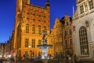 Fountain of Neptune in Gdansk illuminated in evening, Poland, Europe