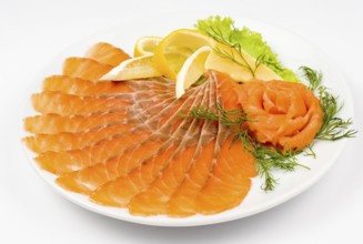 Sliced smoked salmon served with lemon and salmon rose