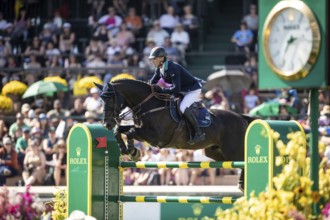 Denis Lynch of Ireland and riding Vistogrand compete in the first round of the 1.60m CPKC