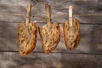 Slice of whole wheat bread sourdough baked in a wood oven hanging