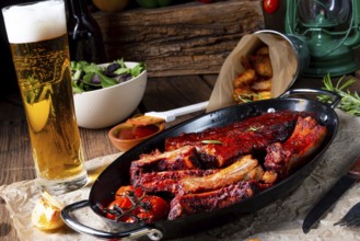 Grilled ribs in a spicy marinade with salad and vegetables
