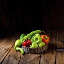 Various harvested peppers and hot peppers in basket