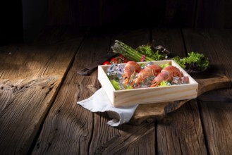 Cooked argentine red prawns with salad on the ice