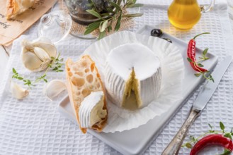 Soft cheese with spicy olives