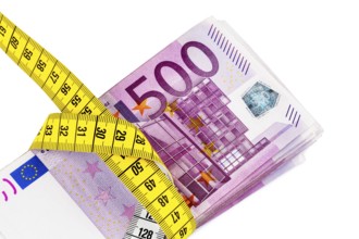 Banknotes and tape measure, symbolic photo for austerity measures, budget consolidation and