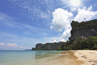 Beach paradise on island Phi-Phi, Thailand. Bright green water of a gulf and light gentle sand