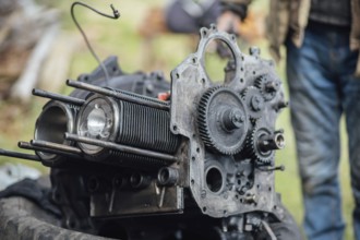 View of mechanical parts of an engine being repaired outside