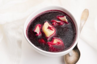 Christmas beetroot soup, borscht with small dumplings with mushroom filling