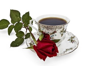 Coffee in a cup with a pattern of roses and flower red rose isolated on white background