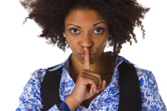 Young African American woman holding index finger in front of mouth - cropped on white background