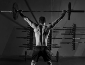 Barbell weight lifting man rear view back workout exercise at gym box