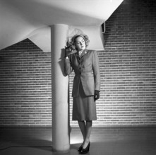 Women's fashion in the 1940s. A young woman in a typical 1940s outfit with a matching skirt and