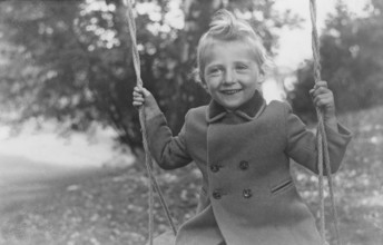 King Harald of Norway. Pictured on a swing as a little boy