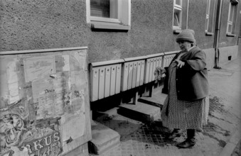 Germany, Wolfen, 31.03.1992, Street, Woman cleaning lockers, Europe