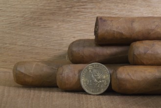Luxury Cuban cigars with US dollar on the wooden table