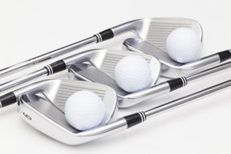 Titanium golf clubs on the white background