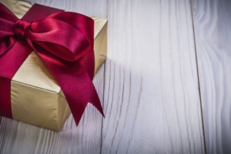 Wrapped birthday gift box on wooden board holidays concept