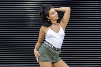 A young woman dancing confidently in urban style