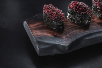 Close Up View Gunkan Maki Sushi On Dark Wooden Board