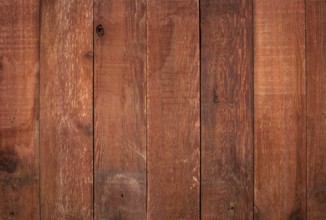 Red weathered barn wood background with knots and nail holes
