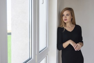 Beautiful girl looks in a new apartment in a new building