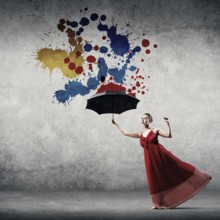 Passionate woman dancer in red dress with black umbrella in hand