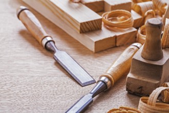 Chisels plane planks shavings on wooden board
