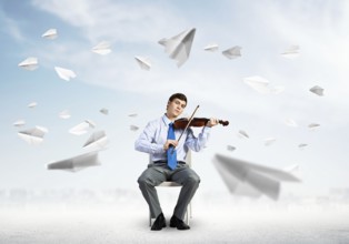 Young businessman is engaged in music, concept of creative chaos in business